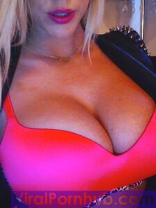 Smiling Blonde Chick Xo Gisele Is Playing With Her Enormous Boobs Before The Camera